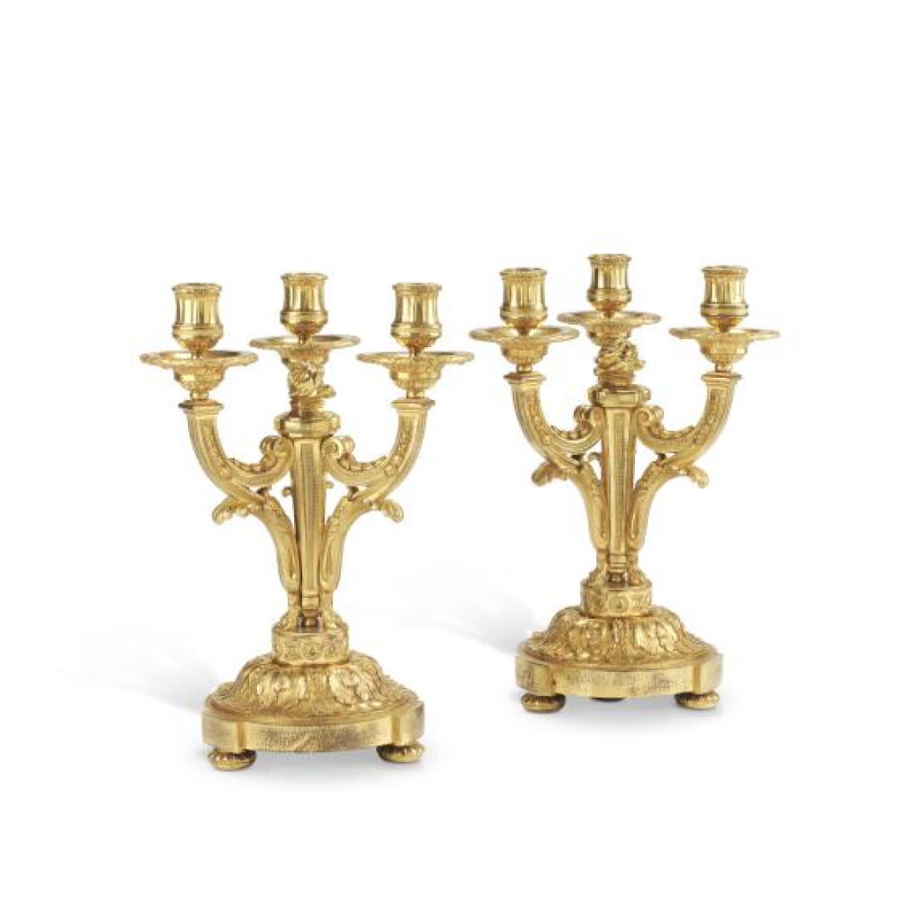 View full screen - View 1 of Lot 177. A pair of Louis XVI gilt-bronze three-light candelabra, in the manner of Jean-Charles Delafosse, last quarter 18th century.