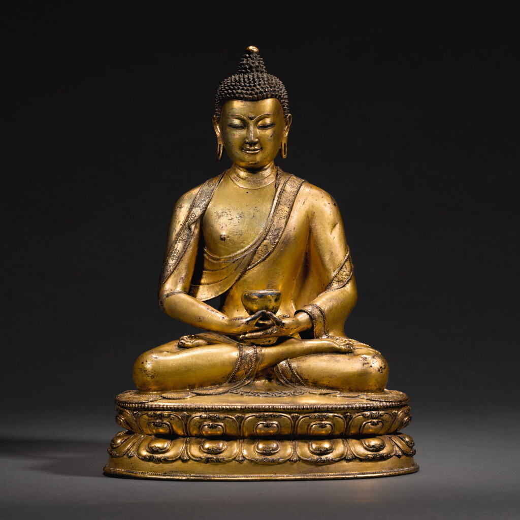 View full screen - View 1 of Lot 152. A GILT-COPPER-ALLOY FIGURE OF BHAISAJYAGURU, TIBET, 15TH CENTURY | 十五世紀 藏傳鎏金銅合金藥師佛坐像.