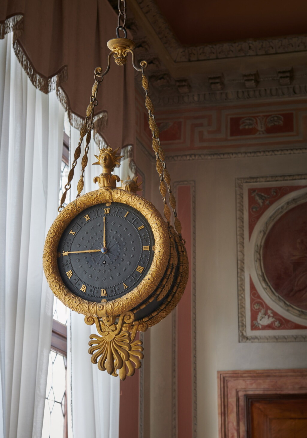 View full screen - View 1 of Lot 45. A Restauration ormolu and patinated bronze double-sided wall timepiece, circa 1825 | Pendule suspendue en bronze patiné et doré d'époque Restauration, vers 1825.