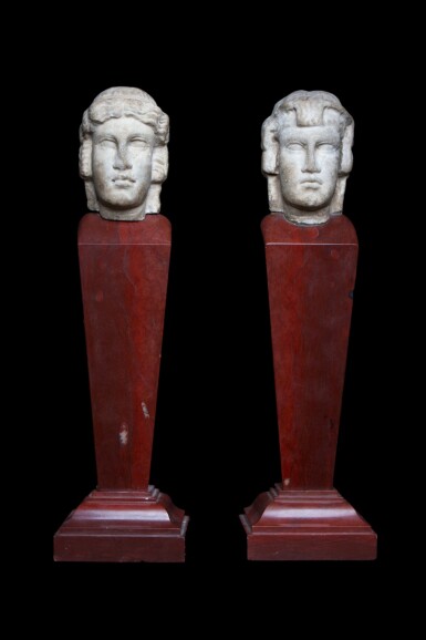 View full screen - View 1 of Lot 97. Two Roman Marble Janiform Herm Heads, circa 2nd century A.D., mounted as a pair on red marble shafts, probably in the 19th Century, circa 1st Century A.D..