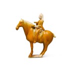 A rare amber-glazed figure of an equestrian drummer, Tang dynasty