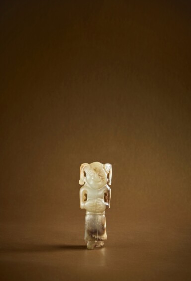 View full screen - View 1 of Lot 106. An extremely rare pale green and brown jade carving of a human, Western Zhou dynasty .