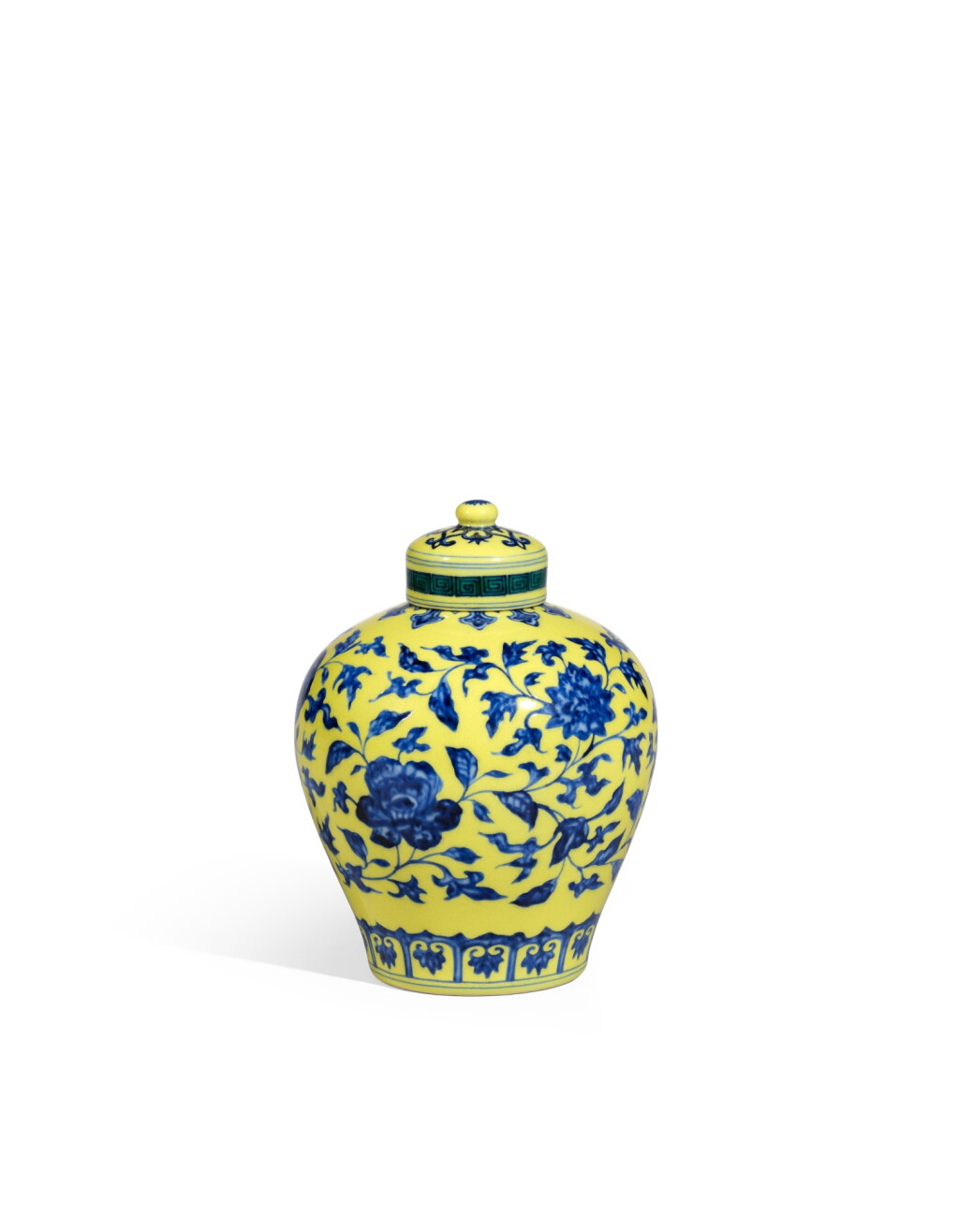 View full screen - View 1 of Lot 6033. A fine and very rare yellow-ground and underglaze-blue 'floral' jar and cover, Mark and period of Yongzheng | 清雍正 黄地青花纏枝花卉紋蓋罐 《大清雍正年製》款.