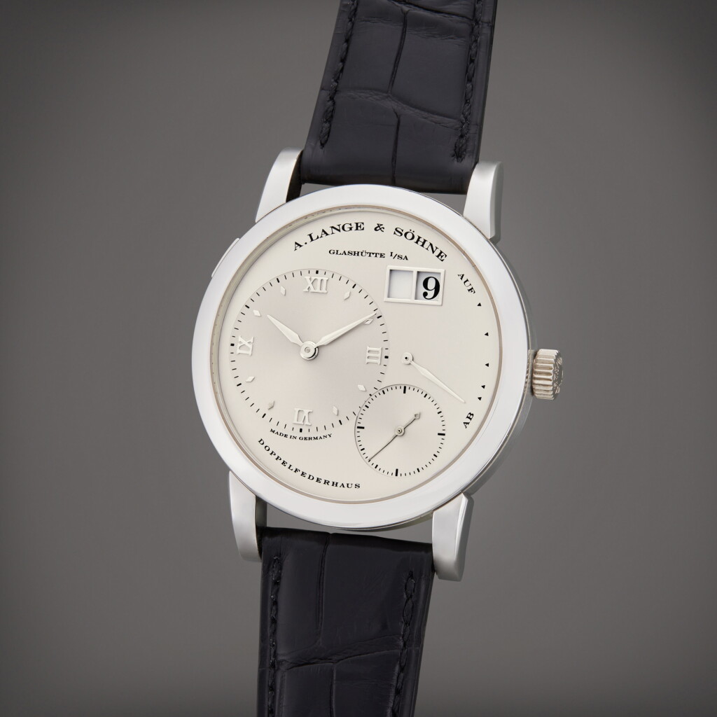 View full screen - View 1 of Lot 7. A platinum wristwatch with date and power reserve indication, Circa 2000.