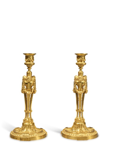 View full screen - View 1 of Lot 96. A Pair of Louis XVI Style Gilt Bronze Candlesticks, After the Model by Etienne Martincourt, 19th Century.