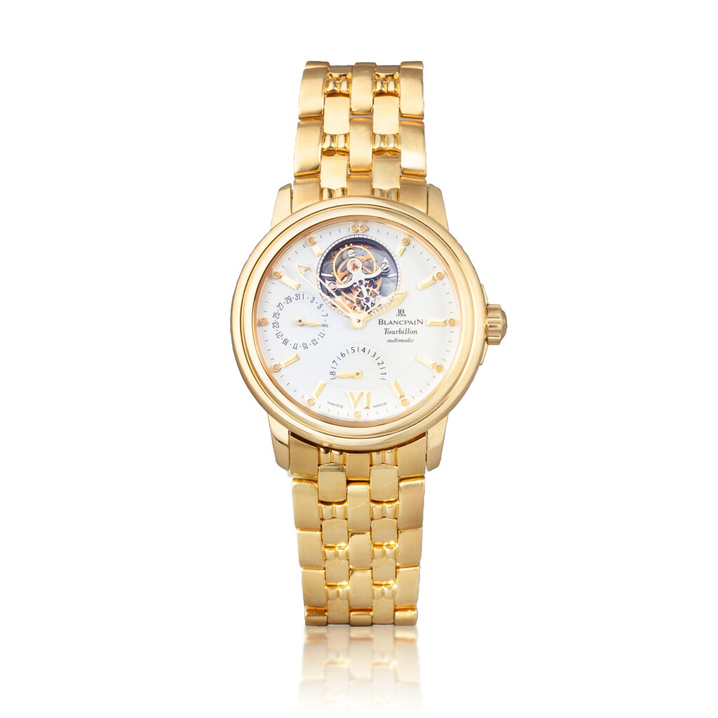 View full screen - View 1 of Lot 1057. Montre bracelet en or jaune avec jour, indication de réserve de marche, tourbillon et bracelet | Yellow gold tourbillon wristwatch with date, power reserve indication and bracelet Vers 1990 | Circa 1990.