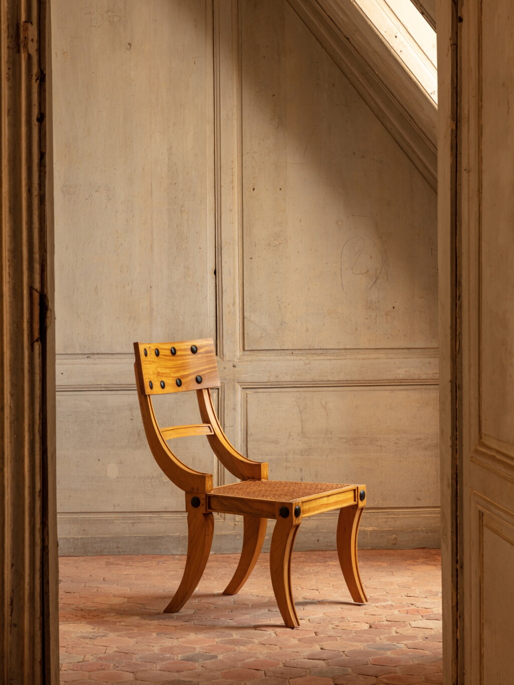 View full screen - View 1 of Lot 61. A set of twelve Regency-style satinwood dining chairs, circa 2000 | Suite de douze chaises klismos en bois satiné, vers 2000.