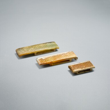 View full screen - View 1 of Lot 752. Three celadon jade scabbard slides, Han dynasty | 漢 青玉榖紋劍璏兩件及卷雲紋劍璏一件.