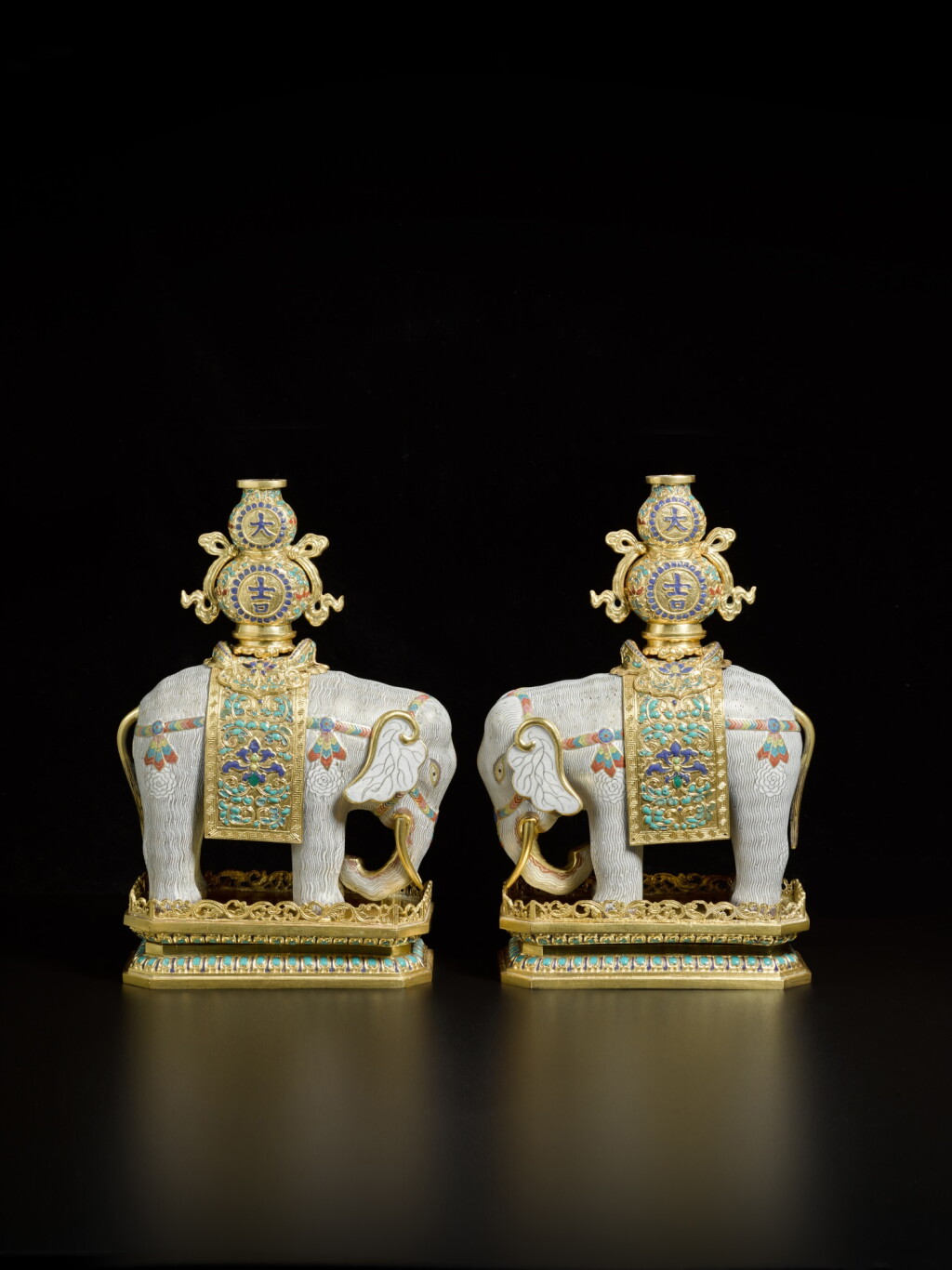 View full screen - View 1 of Lot 244. A pair of gilt-bronze and cloisonné enamel caparisoned elephants and stands, Qing dynasty, Qianlong period.