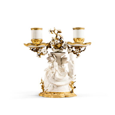View full screen - View 1 of Lot 345. A Louis XV gilt-bronze mounted Chinese porcelain two-light candelabra, Kangxi period (1622-1722), circa 1750 | Candélabre à deux lumières en porcelaine blanc de Chine d'époque Kangxi (1622-1722) et monture de bronze doré d'époque Louis XV, vers 1750.