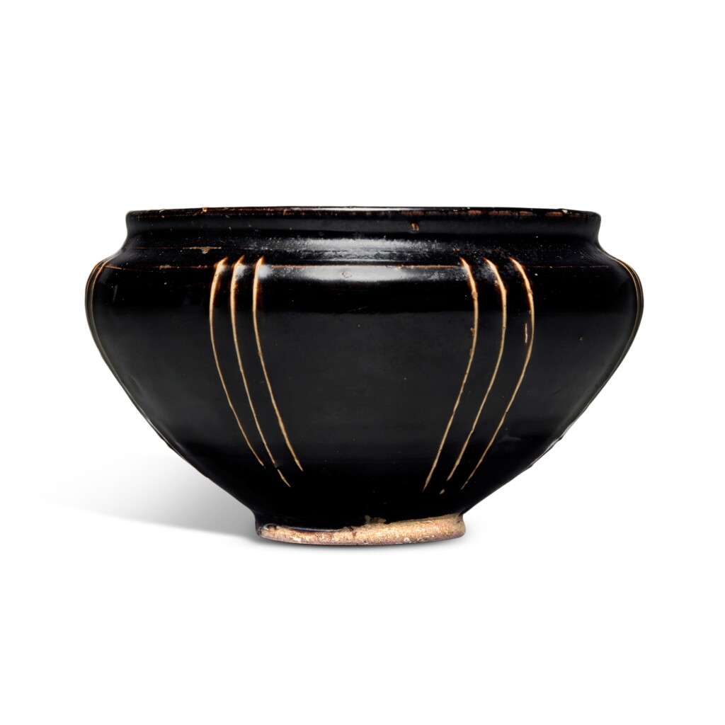 View full screen - View 1 of Lot 1146. A slip-decorated black-glazed jar, Jin dynasty | 金 黑釉棱線紋罐.