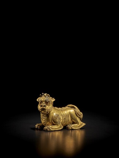 View full screen - View 1 of Lot 125. A gilt-bronze 'mythical beast' weight, Ming dynasty | 明 銅鎏金瑞獸形鎮.