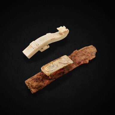 View full screen - View 1 of Lot 3016. An archaic jade scabbard slide and an archaic 'chilong' belt hook, Eastern Zhou dynasty, Warring States period - Western Han dynasty 東周戰國至西漢 玉劍璏及龍首帶鉤一組兩件.
