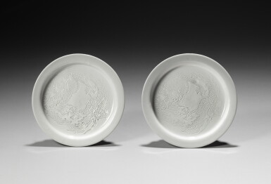 View full screen - View 1 of Lot 167. A pair of white-glazed incised 'dragon' dishes, Qing dynasty | 清 白釉暗刻龍紋折沿盤一對.