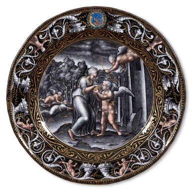 View full screen - View 1 of Lot 118. A Limoges grisaille painted enamel circular plate with Cupid and Psyche, Attributed to Pierre Reymond (1513-1584), circa 1570-1575.