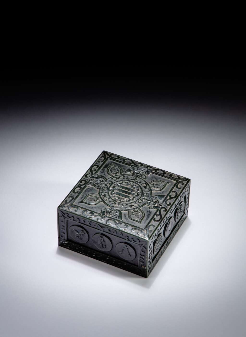 View full screen - View 1 of Lot 59. A spinach jade 'twelve symbol' square seal-paste box and cover, Qing dynasty, 18th - 19th century | 清十八至十九世紀 青玉雲龍十二章紋方蓋盒.