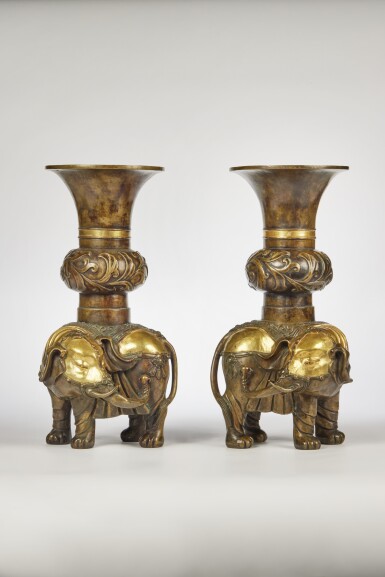 View full screen - View 1 of Lot 61. A Pair of Chinese Parcel-Gilt Bronze Caparisoned 'Elephant' Vases, Qing Dynasty, 18th Century | 清十八世紀 銅局部鎏金太平有象擺件一對.