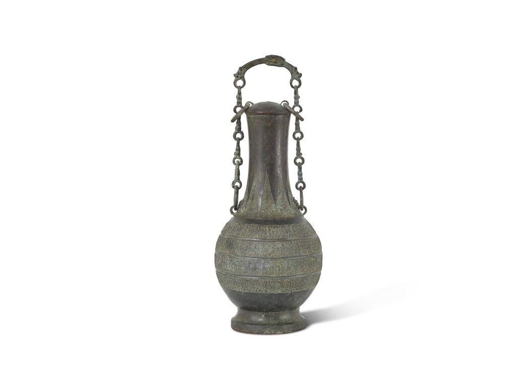 View full screen - View 1 of Lot 5035. An archaic bronze ritual wine vessel and cover, hu Warring States period 戰國 青銅提樑壺.