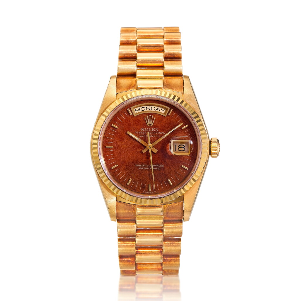 View full screen - View 1 of Lot 38. Reference 18038 Day-Date, A yellow gold automatic wristwatch with day, date, bracelet and wood dial, Circa 1985 勞力士 18038型號 Day-Date 黃金自動上鏈鍊帶腕錶備星期及日期顯示,配木製錶盤,約1985年製.