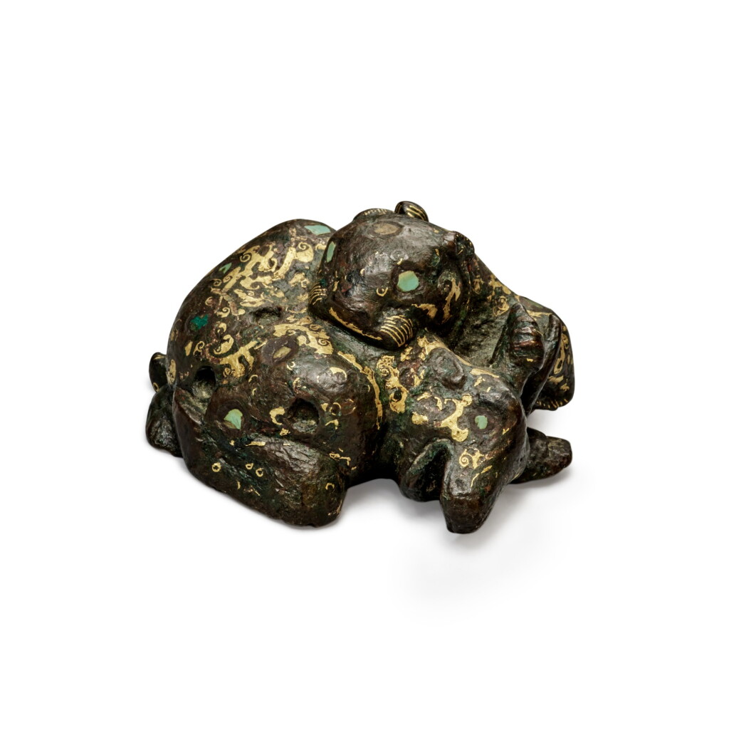 View full screen - View 1 of Lot 7. A gold, turquoise and malachite-inlaid bronze weight, Early Western Han dynasty | 西漢初 銅錯金嵌寶虎獵羊形鎮.