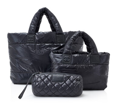View full screen - View 1 of Lot 102. SET OF THREE BLACK/BURGUNDY PADDED NYLON COCO COCOON BAGS, CHANEL.