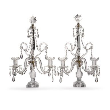 View full screen - View 1 of Lot 52. A pair of George III cut-glass twin-branch table candelabra, late 18th/early 19th century, in the manner of Parker and Perry.