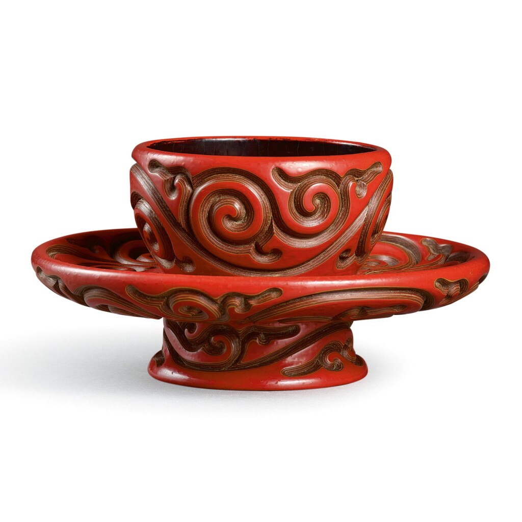 View full screen - View 1 of Lot 59. A CINNABAR 'TIXI' LACQUER CUP STAND SIGNED YANG MAO, YUAN DYNASTY | 元 朱面剔犀卷草紋盞托 《楊茂造》款.