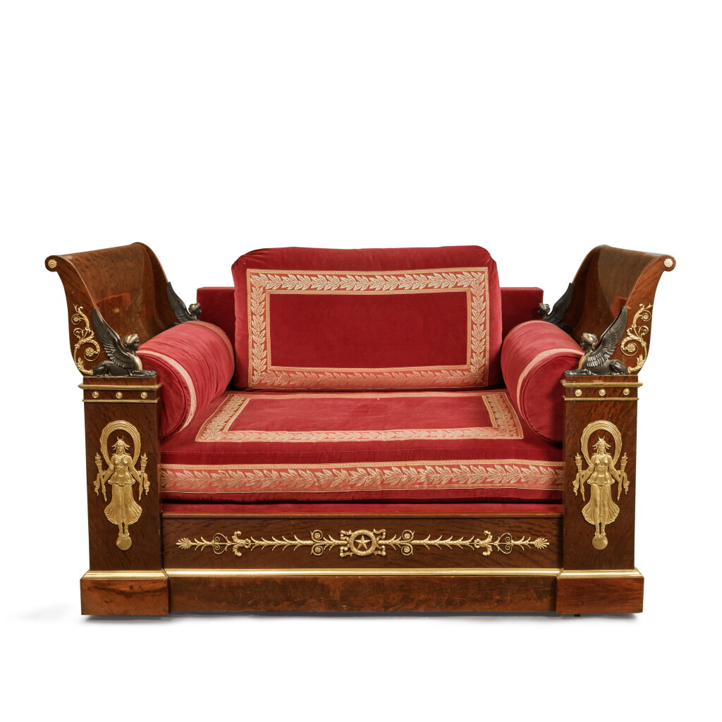 View full screen - View 1 of Lot 63. An Empire Gilt and Patinated Bronze-Mounted Mahogany and Plum Pudding Mahogany Lit en Bateau, Early 19th Century.