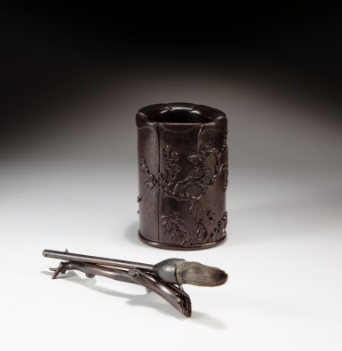 View full screen - View 1 of Lot 174. A 'zitan' magnolia-shaped 'prunus and lotus' brushpot, Qing dynasty, 18th century, and a brush with a wood brushrest, Republican period | 清十八世紀 紫檀梅花枝蓮紋玉蘭花式筆筒及民國 毛筆及枝形筆擱一組三件.