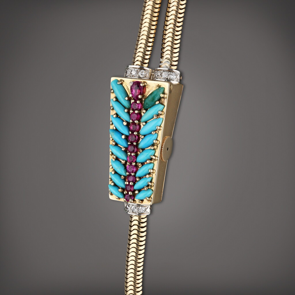 View full screen - View 1 of Lot 97. Retailed by Cartier: A yellow gold and diamond, rubies and turquoise-set trapeze-shaped concealed bracelet watch, Made in 1944.
