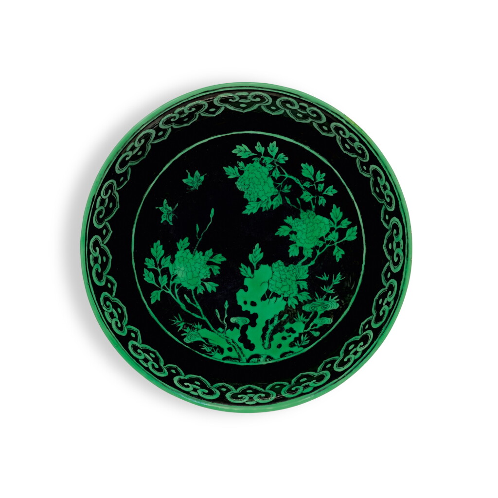 View full screen - View 1 of Lot 151. A black-ground green-enamelled 'butterfly and flower' dish, Seal mark and period of Qianlong | 清乾隆 墨地綠彩蝶戀花紋盤 《大清乾隆年製》款.