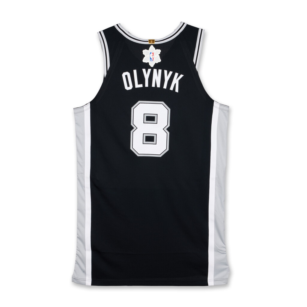 View full screen - View 1 of Lot 42. Kelly Olynyk ‘Christmas Day’ San Antonio Spurs 2025-2026 Game Issued Icon Edition Jersey | Probable Wear.