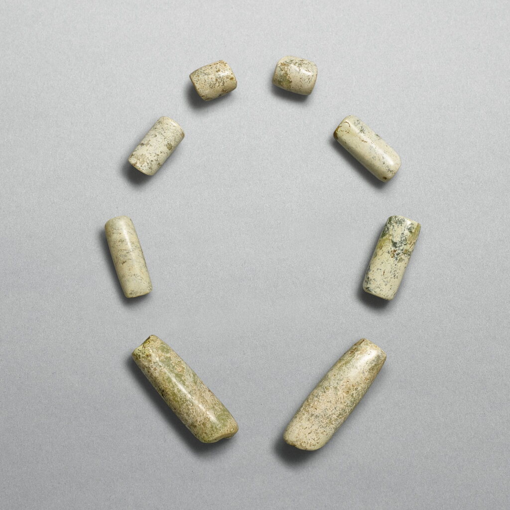 View full screen - View 1 of Lot 702. A set of eight celadon jade beads, Neolithic period, Xinglongwa culture | 新石器時代 興隆窪文化 玉管一組八件.