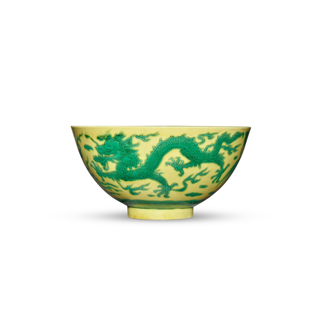 View full screen - View 1 of Lot 130. A yellow-ground green-enameled 'dragon and phoenix' bowl, Mark and period of Kangxi | 清康熙 黃地綠彩龍鳳呈祥紋盌 《大清康熙年製》款.