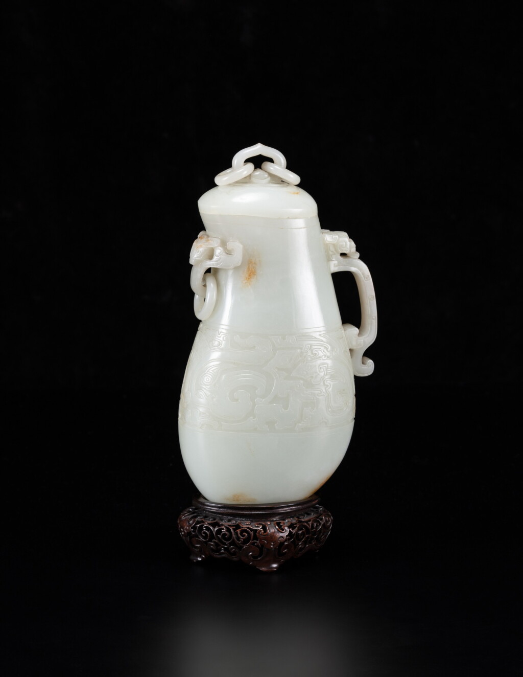 View full screen - View 1 of Lot 6. An exceptional white and russet jade archaistic ewer and cover Qing dynasty, Qianlong period | 清亁隆 白玉雕仿古鳳凰紋活環連蓋匜.