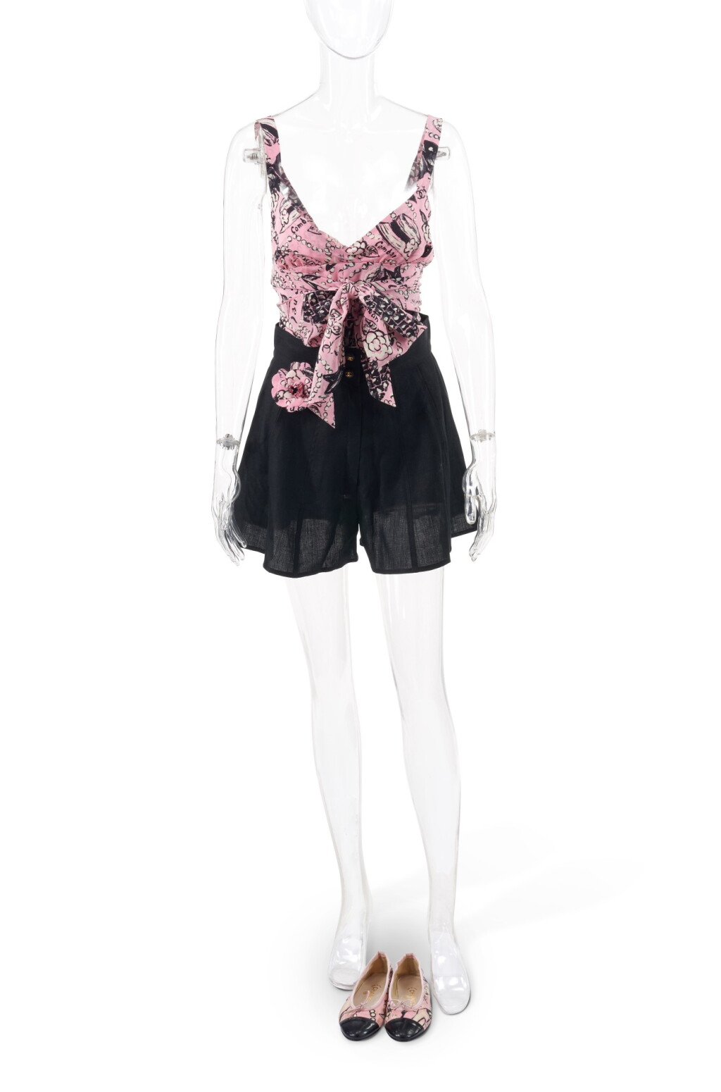 View full screen - View 1 of Lot 59. CHANEL | PINK CAMELLIA PRINT SILK TOP WITH BLACK SHORTS AND MATCHING BROOCH AND PAIR OF FLATS .