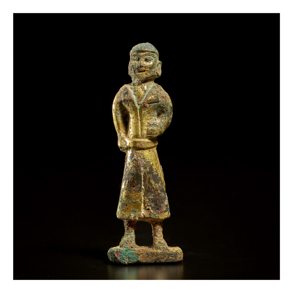 View full screen - View 1 of Lot 582. A GILT-BRONZE FIGURE OF A FOREIGN MERCHANT, TANG DYNASTY.