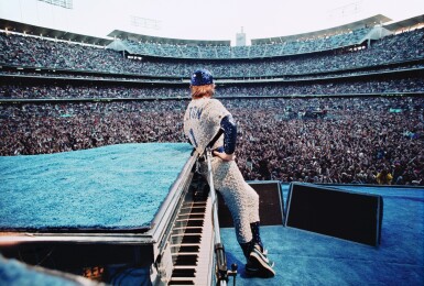 View full screen - View 1 of Lot 18. TERRY O'NEILL | ELTON JOHN, DODGER STADIUM, 1975 .