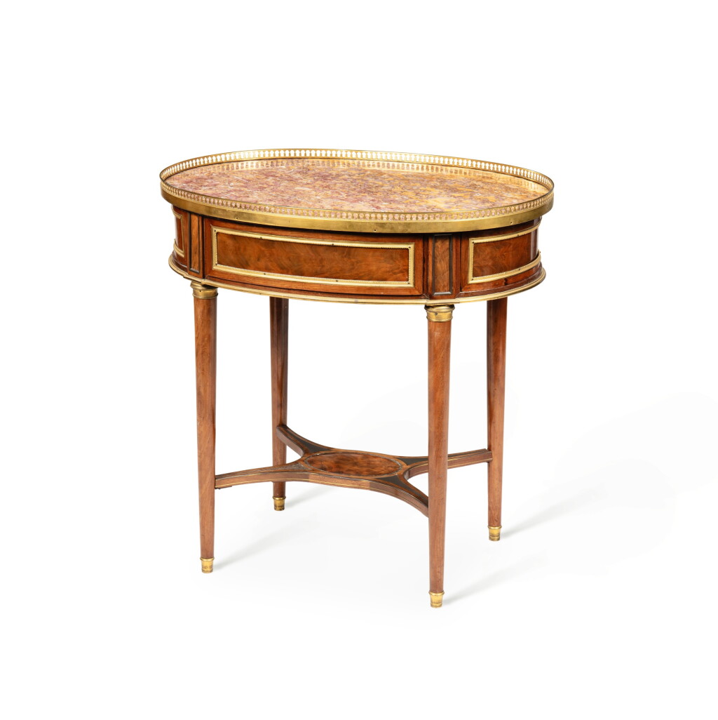 View full screen - View 1 of Lot 116. A Louis XVI gilt-bronze mounted mahogany and plumpudding mahogany veneered mecanism table, circa 1785 | Table ovale à mécanisme en acajou, placage d'acajou flammé et bronze doré d'époque Louis XVI, vers 1785.