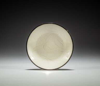 View full screen - View 1 of Lot 54. A carved 'Ding' 'lotus' dish, Northern Song dynasty | 北宋 定窰白釉刻蓮花紋盤.