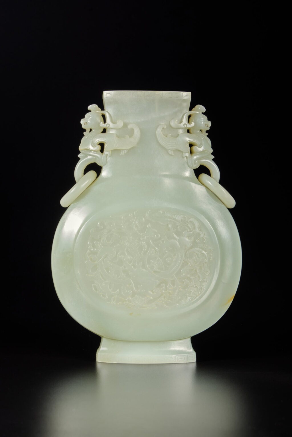 View full screen - View 1 of Lot 282. A pale celadon jade 'chilong' vase, Qing dynasty, Qianlong period | 清乾隆 青白玉雕穿花龍紋鳳耳銜環扁瓶.