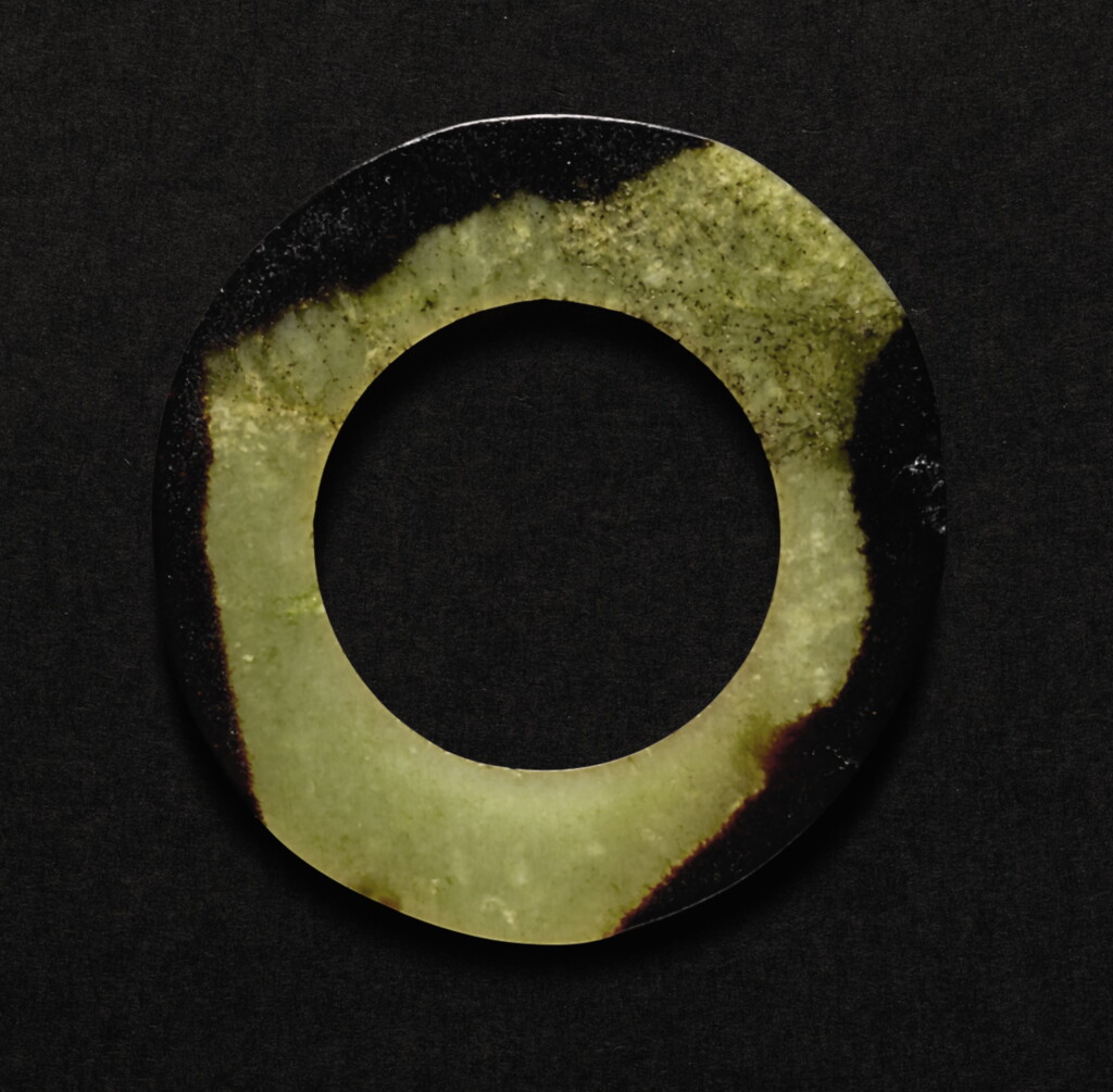 View full screen - View 1 of Lot 225. A CELADON AND BROWN JADE RING LATE SHANG DYNASTY -WESTERN ZHOU DYNASTY | 商晚期至西周 褐斑青玉環.