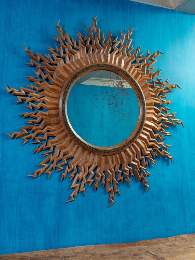 View full screen - View 1 of Lot 4. A large carved teak mirror with lightning bolts, designed by Andrew Allfree (b. 1956) | Miroir aux éclairs en teck, XXe siècle, conçu par Andrew Allfree (n. 1956).