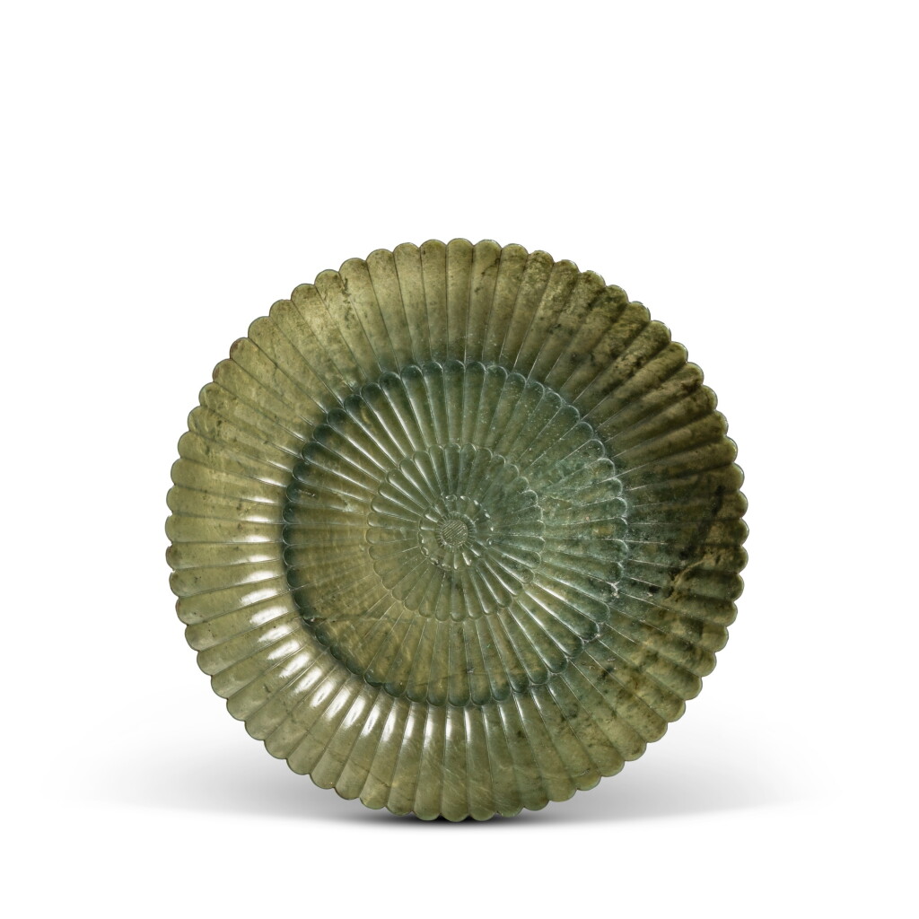 View full screen - View 1 of Lot 601. A Mughal-style green jade 'chrysanthemum' dish, Qing dynasty, 18th / 19th century.