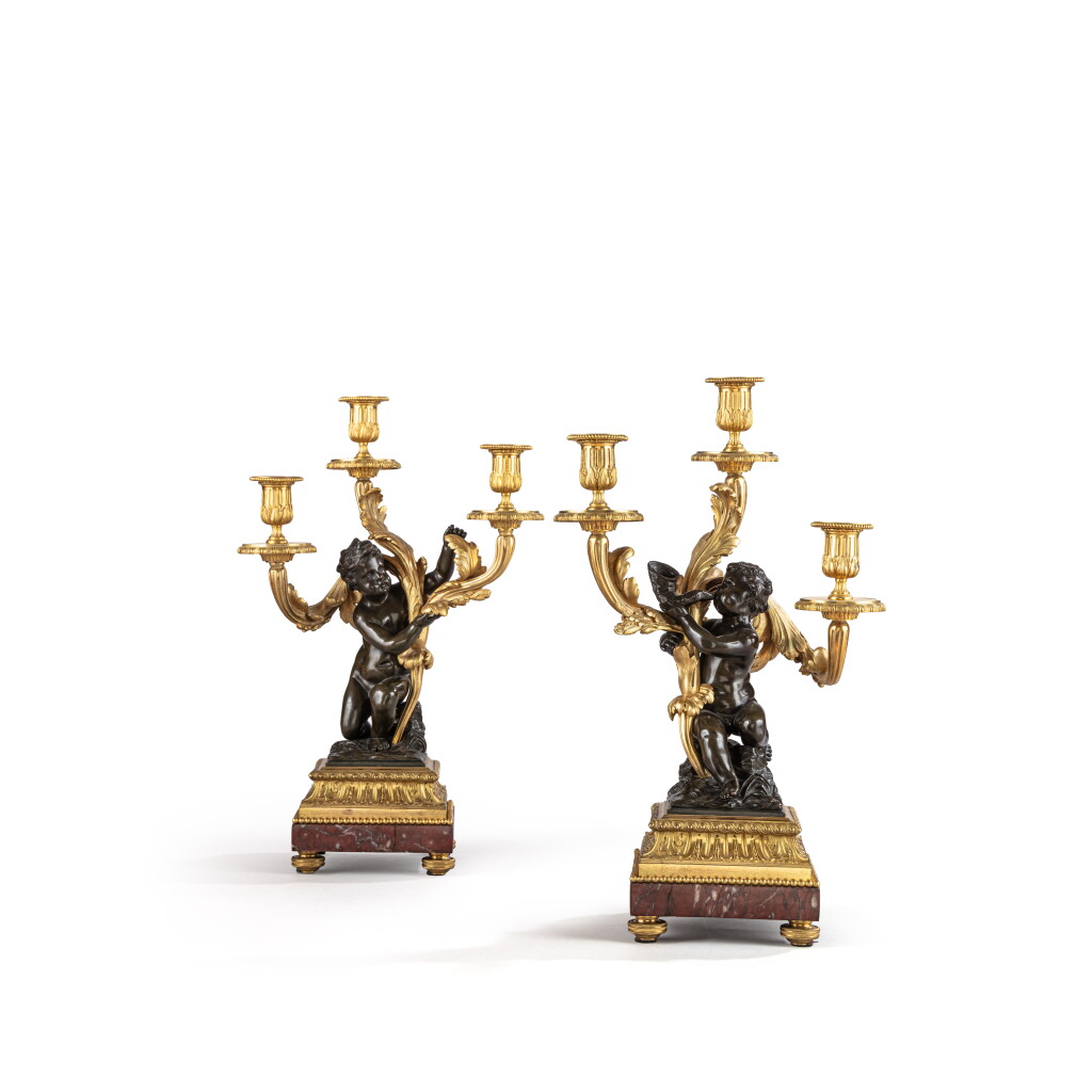 View full screen - View 1 of Lot 656. A pair of Louis XVI style gilt and patinated bronze three-light candelabra, late 19th century.