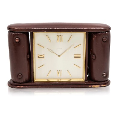 View full screen - View 1 of Lot 44. A large and unusual gilt brass travel timepiece with fitted leather case, Circa 1945 卡地亞 大型珍罕鍍金銅旅行座鐘附皮革錶盒,約1945年製.