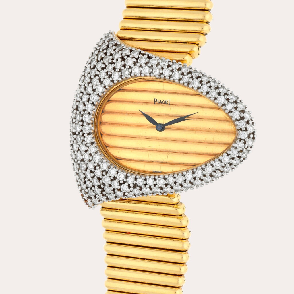 View full screen - View 1 of Lot 121. Reference 98481 C10 | A yellow gold and diamond-set bracelet watch | Circa 1974.
