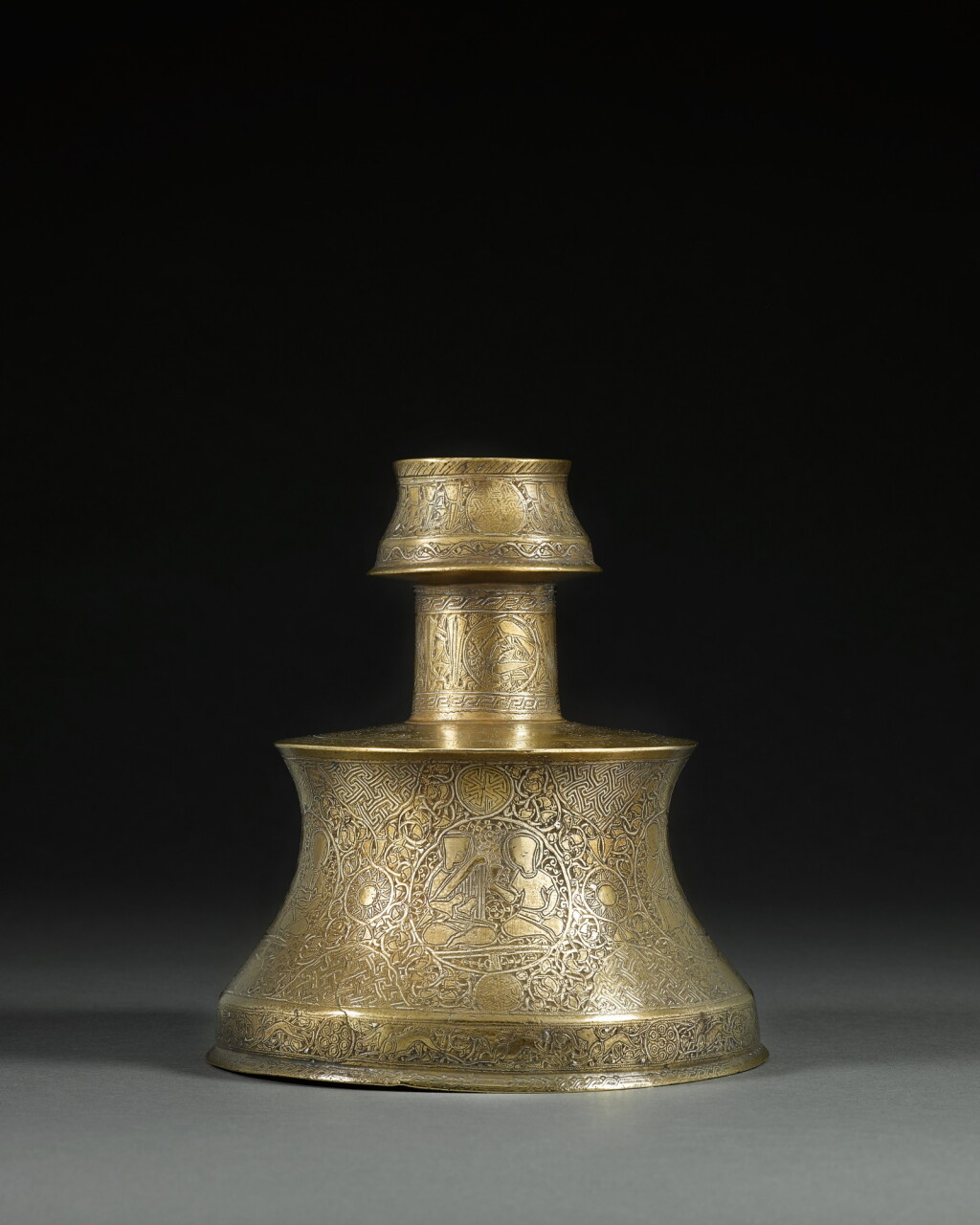 View full screen - View 1 of Lot 103. A gold and silver-inlaid brass candlestick, Eastern Anatolia or Jazira, 13th/14th century.