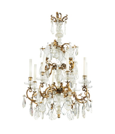 View full screen - View 1 of Lot 7. A gilt metal and cut rock crystal chandelier, French Régence style, with some old elements | Lustre en métal doré à l'huile et pendeloques en cristal de roche taillé de style Régence, comportant des éléments anciens.
