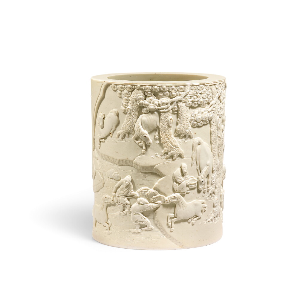 View full screen - View 1 of Lot 393. A rare carved white biscuit porcelain 'horse' brushpot, Qing dynasty, 18th - 19th century 清十八至十九世紀 素胎白瓷浴馬圖筆筒.